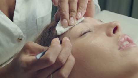 woman getting eyebrow treatment