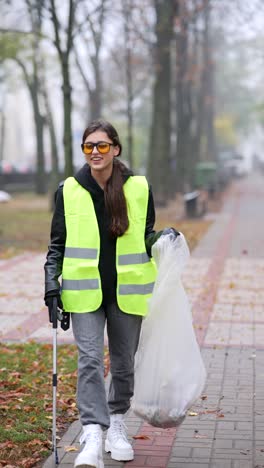 woman cleaning up litter in a park