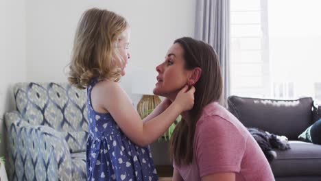 Caucasian-mother-and-daughter-having-fun-talking-in-living-room