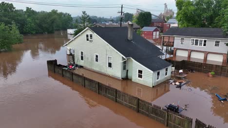 abandoned flood house in american neighborhood. aerial view. hurricane harvey destroying city. dirty and muddy water surrounding building. sad nature catastrophe
