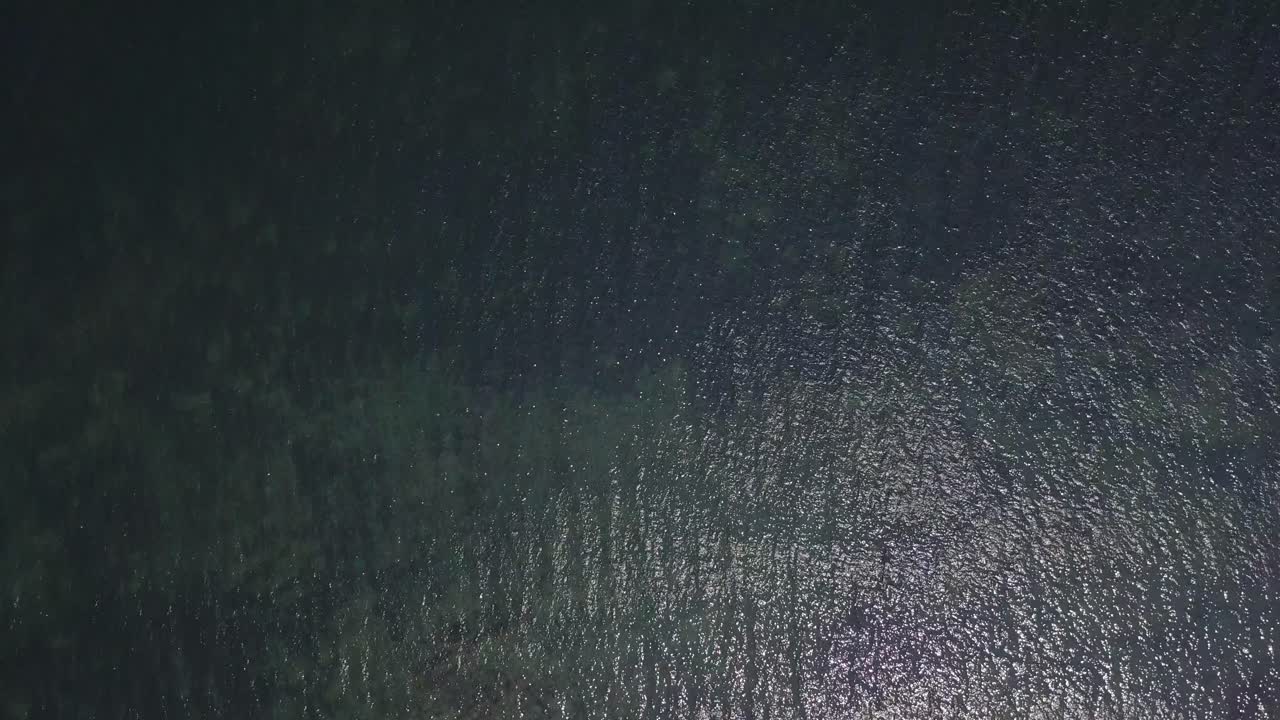 Drone over the Atlantic Ocean panning up to reveal the horizon in Nova Scotia in Canada during the day