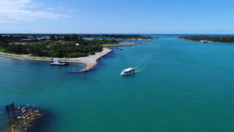 flying-over-boat-in-blue-water-in-Lakes-Entrance