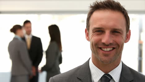 Businessman-smiling-at-the-camera