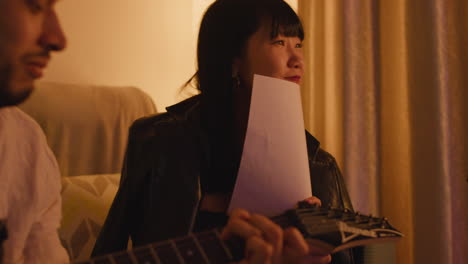 people singing and playing guitar