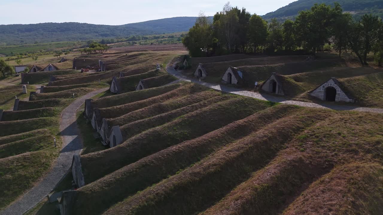 Beautiful aerial flyover of the Kőporosi Pincesor consecutive cellar rows in Hercegkút, Hungary