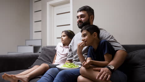 father, daughter and son in the living room at home