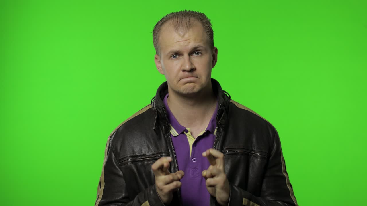 희망으로 가득 찬 로커 남자 손가락을 쳐 행운의 몸짓을 보여주고, 행운을 기원하고, 승리합니다.