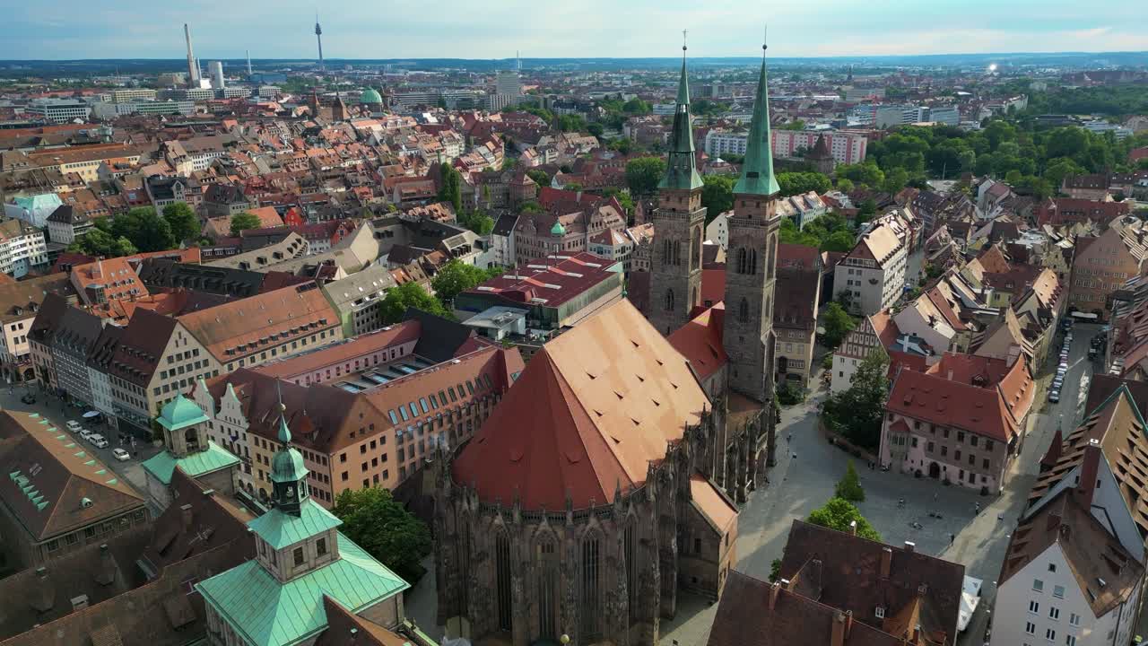 4K Aerial Drone Video of the Copper-clad Twin Spiers and Stained Glass Windows of the Beautiful St. Sebald Church in Downtown Nurnberg, Germany