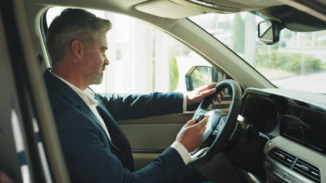 man driving a new car