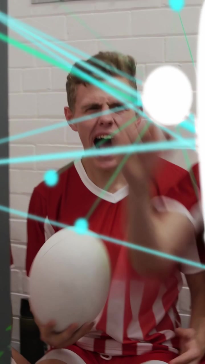 Vertical video: Soccer team reacting to coach pep, lifting white ball with teal lines over heads