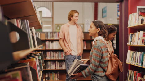 students browsing books in a library