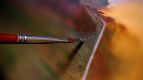 thin focus of wide tip paintbrush painting line dots across desert scape