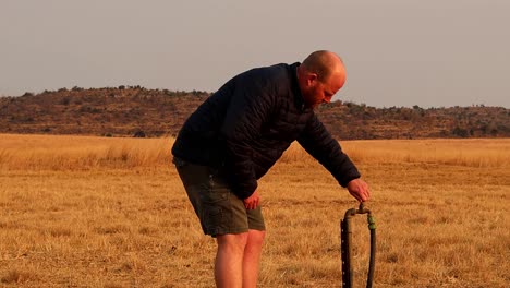 responsible adult male turning off his garden tap, after watering the plants in dry winter conditions