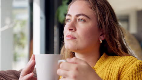 woman with coffee in sweater indoors