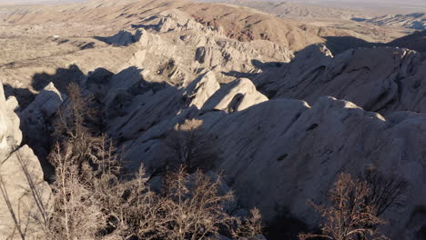 A-drone-captures-a-breathtaking-view-of-the-Devil's-Punchbowl,-California,-showcasing-the-majestic-rock-formations-and-the-surrounding-desert-landscape