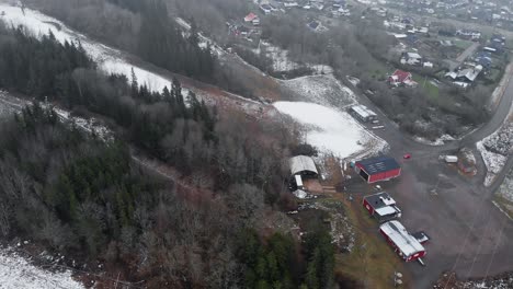 Aerial-reveal-shot-of-Swedish-Ski-resort-in-Winter-with-little-snow