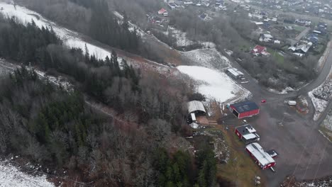 aerial reveal shot of swedish ski resort in winter with little snow