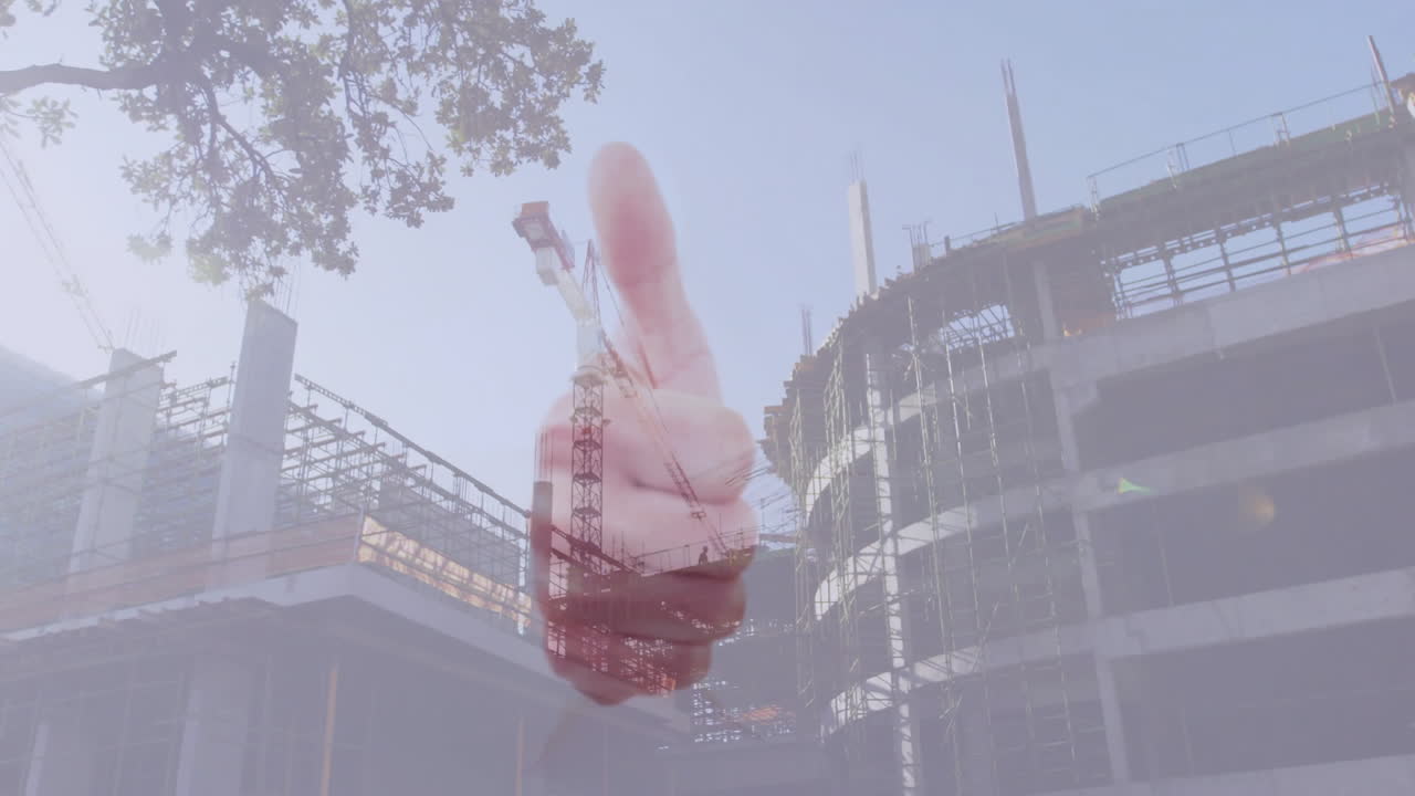 Animation of thumbs up gesture at construction site with cranes and scaffolding