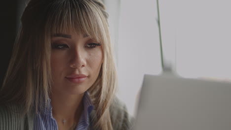 Thoughtful-concerned-chinese-japan-japanese-korean-woman-working-on-laptop-computer-looking-away-thinking-solving-problem-serious-woman-search-for-inspiration-make-decision-feel-lack-of-ideas