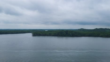 aerial view of the panama canal with lush rainforest and river bend under a dramatic cloudy sky