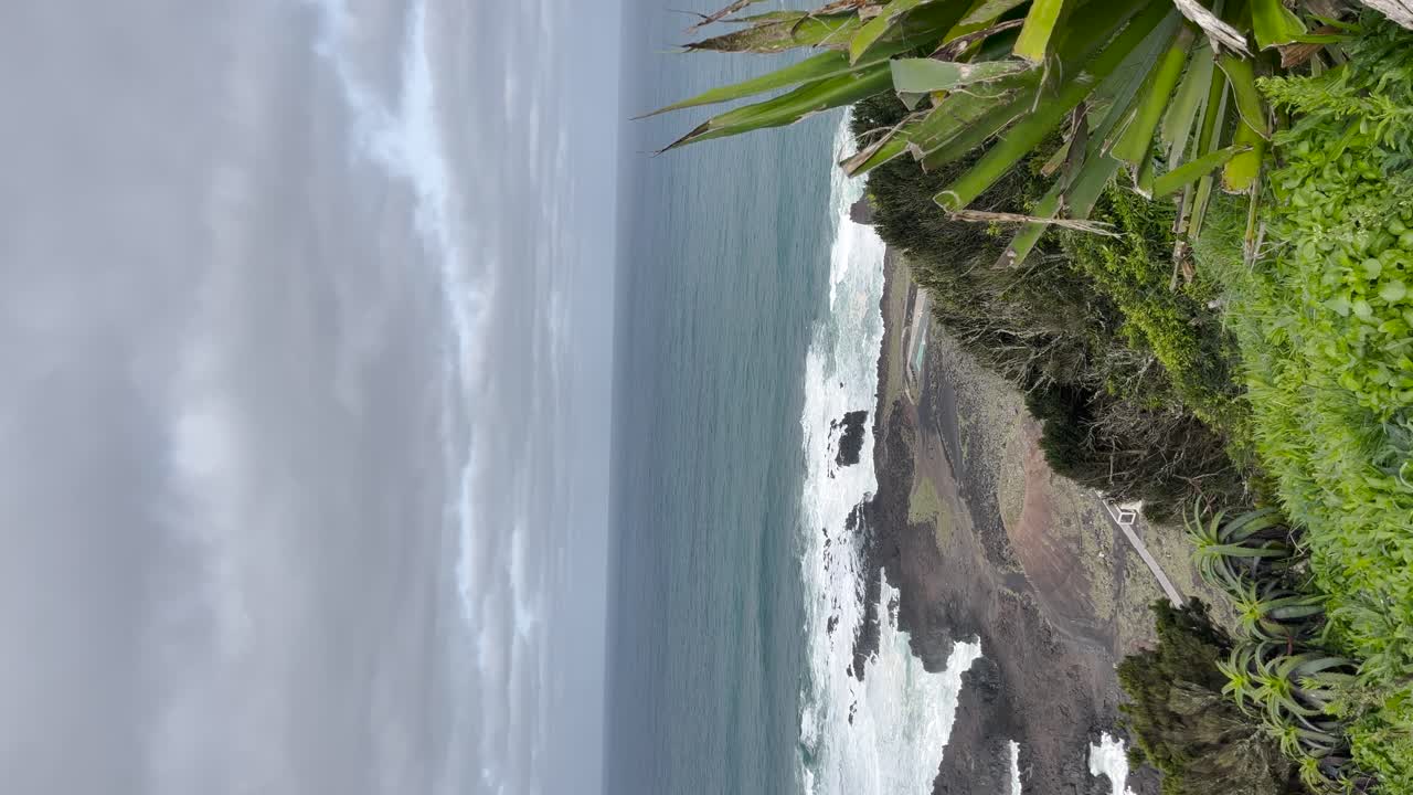 Aa coastline with waves crashing against rocks, suggesting a rugged and natural seaside environment.