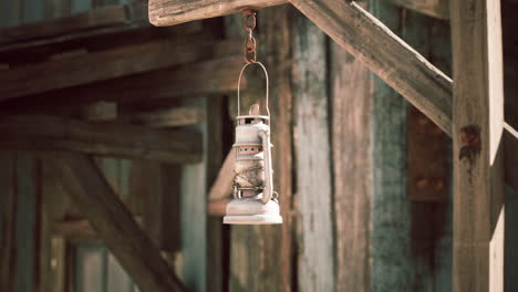 hanging lantern in a rustic wooden setting during daytime light