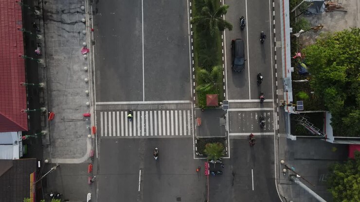 Aerial View of Busy City Intersection with Cars and Motorcycles