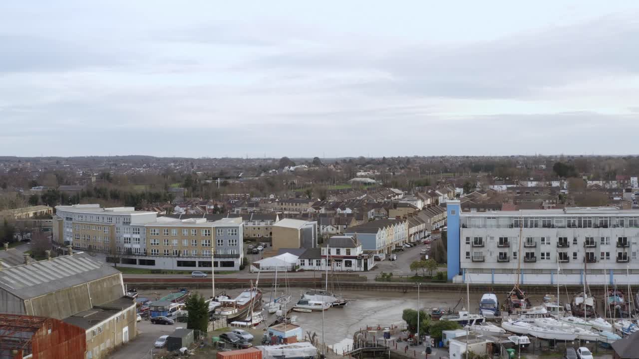Drone hovers above eastern Gravesend showing wharves, roadways, and urban mix