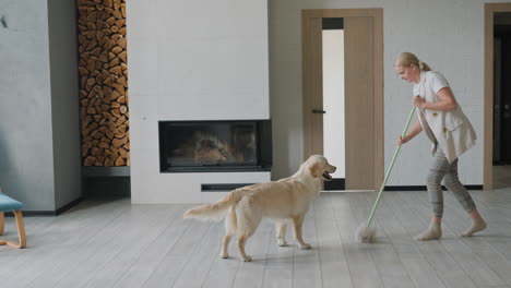 woman cleaning the house with a dog