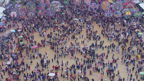 Reveal-shot-of-giant-kites-at-Sumpango-Kite-Festival-Guatemala,-aerial