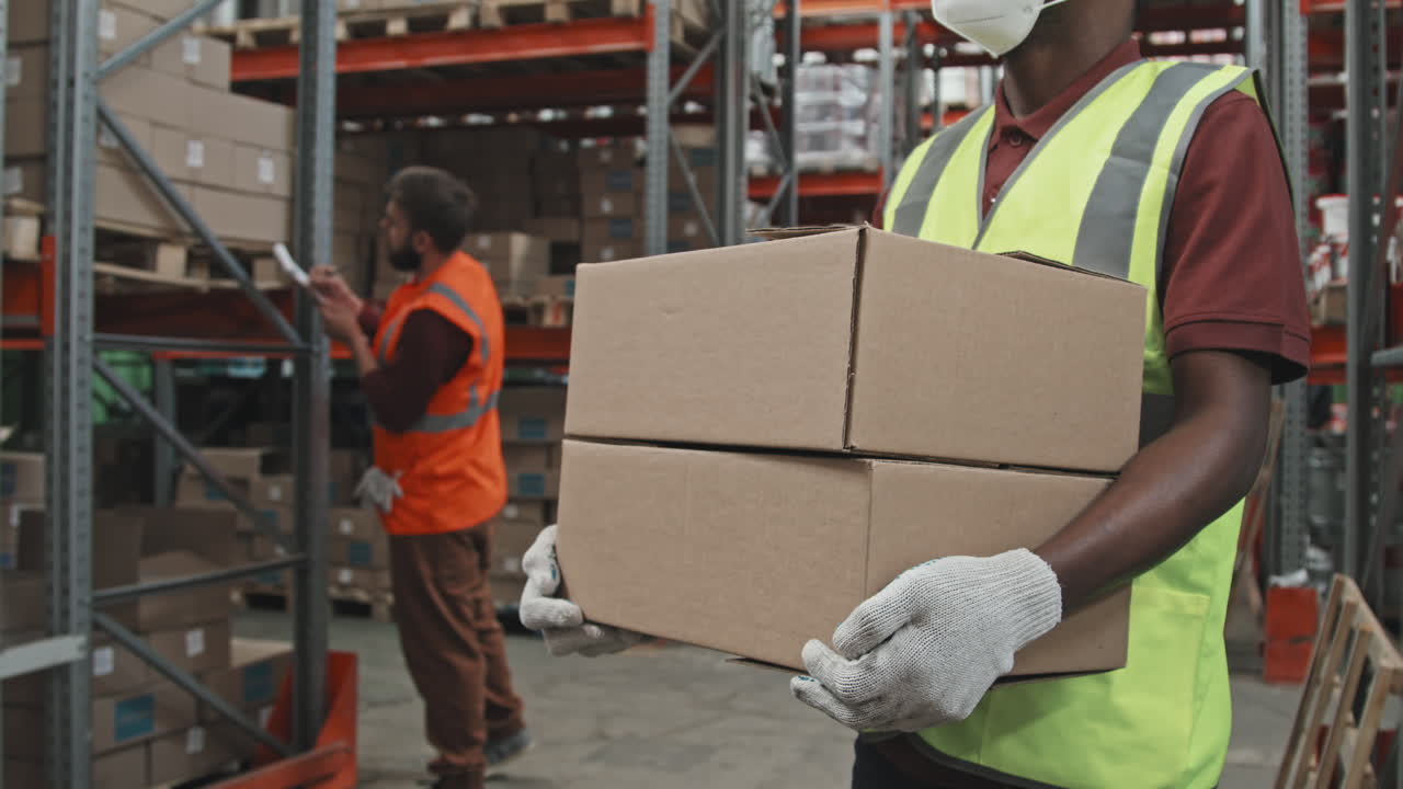 Mid-Section of Warehouse Worker with Boxes