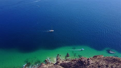 This-is-4K-drone-footage-of-boats,-traveling-in-the-Pacific-Ocean,-off-the-coast-of-Cabo-San-Lucas-Mexico