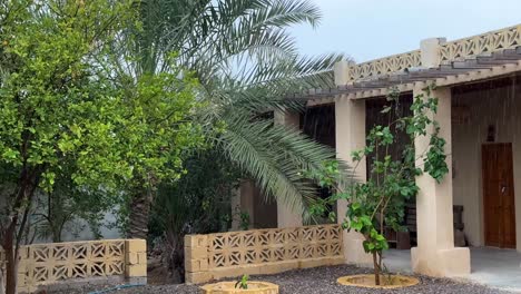 wonderful rare landscape of rainy day in tropical climate arabian culture sea side resort luxury lodge arabic traditional architecture symbol minimal color palm garden wooden door in qeshm island iran