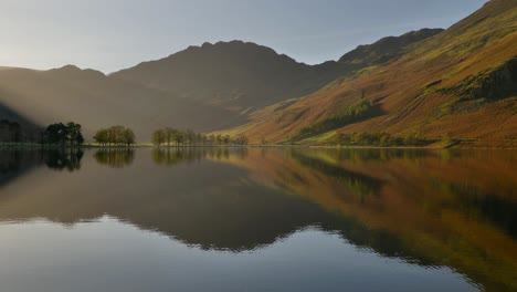 stunning autumn scene at buttermere lake on a still morning