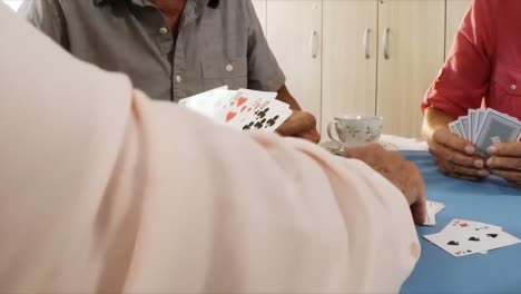 senior man playing cards in old age home