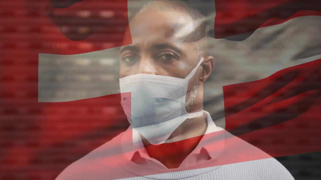 코로나19 전염병 기간 동안 마스크를 쓰고 있는 남자 위에 흔들리는 스위스 국기의 애니메이션