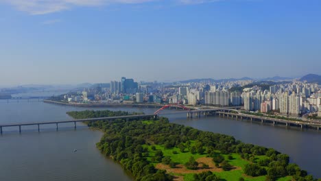 drone shot traveling forward above the han river to the bamseom island in seoul city during a sunny day