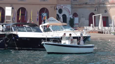 boat with tourists near sorrento quay, naples, italy