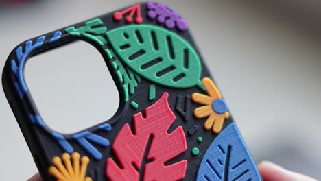 vibrant and artistic phone case featuring colorful floral and leaf patterns, showcasing unique textures and design elements for personal style and protection