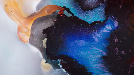 swirling mass of dark blue and black inks mixing in liquid. macro view