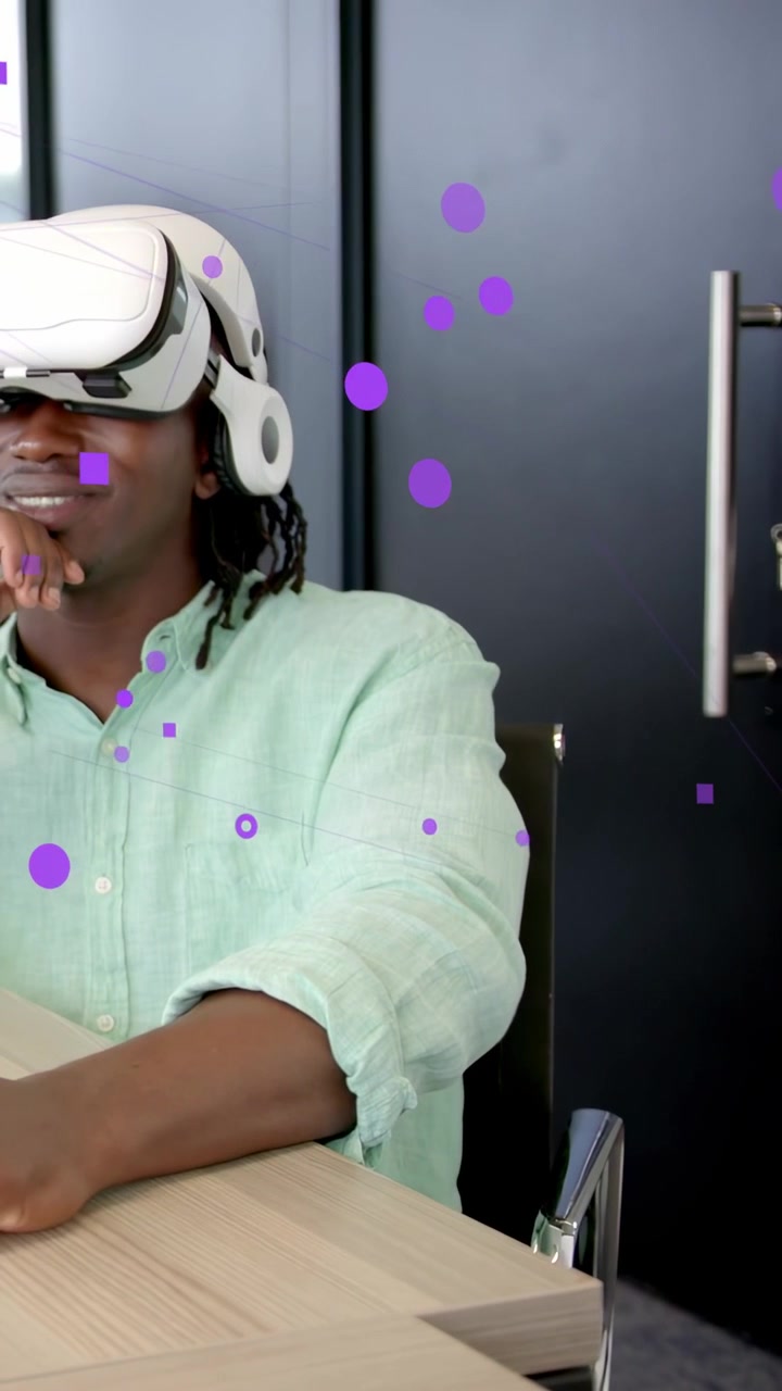 Vertical video: Man with VR headset gesturing on desk, testing interface activating purple overlay