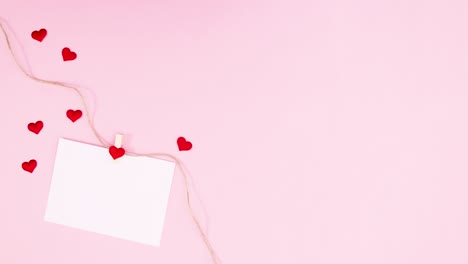 paper for text with hearts hooked on rope moving. stop motion valentine day