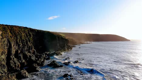 Beach-with-mountain-cliff-and-sea-4k