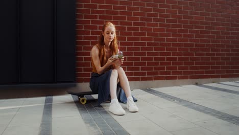 young woman enjoying a drink on her skateboard