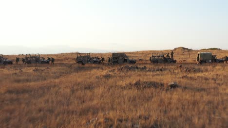 thousands first army soldiers in military cars practicing war in the dry prairie