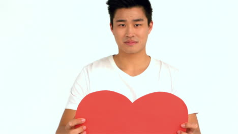 asian man holding red heart shape