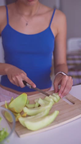woman preparing and cutting cantaloupe