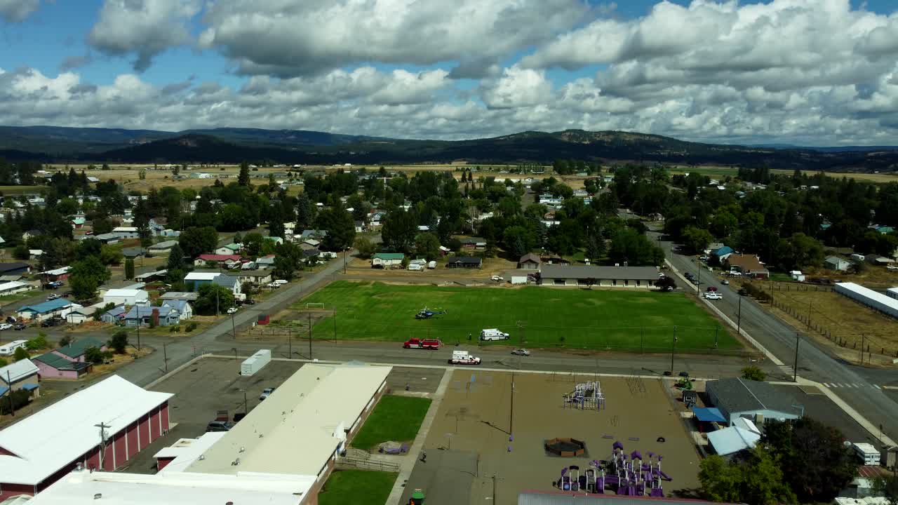 US, Oregon, Elgin, 2025-08-07 - Drone view of a Life Flight helicopter landed in a grass field