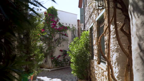 This walkway leads to Marmaris Castle through narrow cobblestone streets surrounded by quaint houses with floral facades.