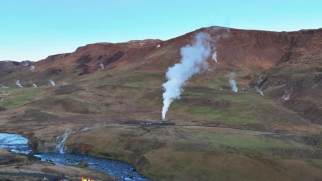 aerial view of steaming hot springs next to hveragerdi town in south iceland - drone shot